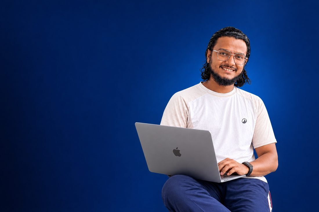 Muhammed Ajmal P smiling with a laptop